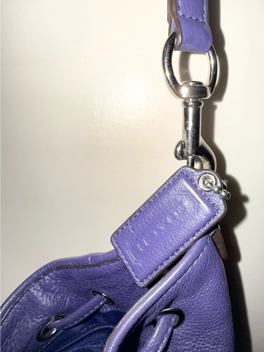 COACH purple pebbled bucket drawsting purse with slouchy silhouette.